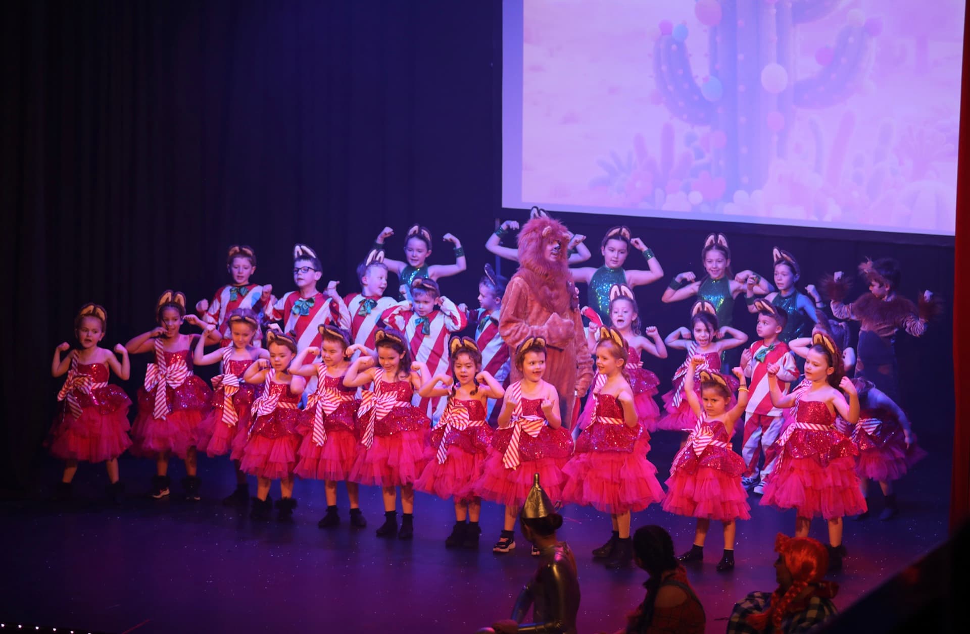 Christmas pantomime number with sparkle costumes and a bear character centre stage