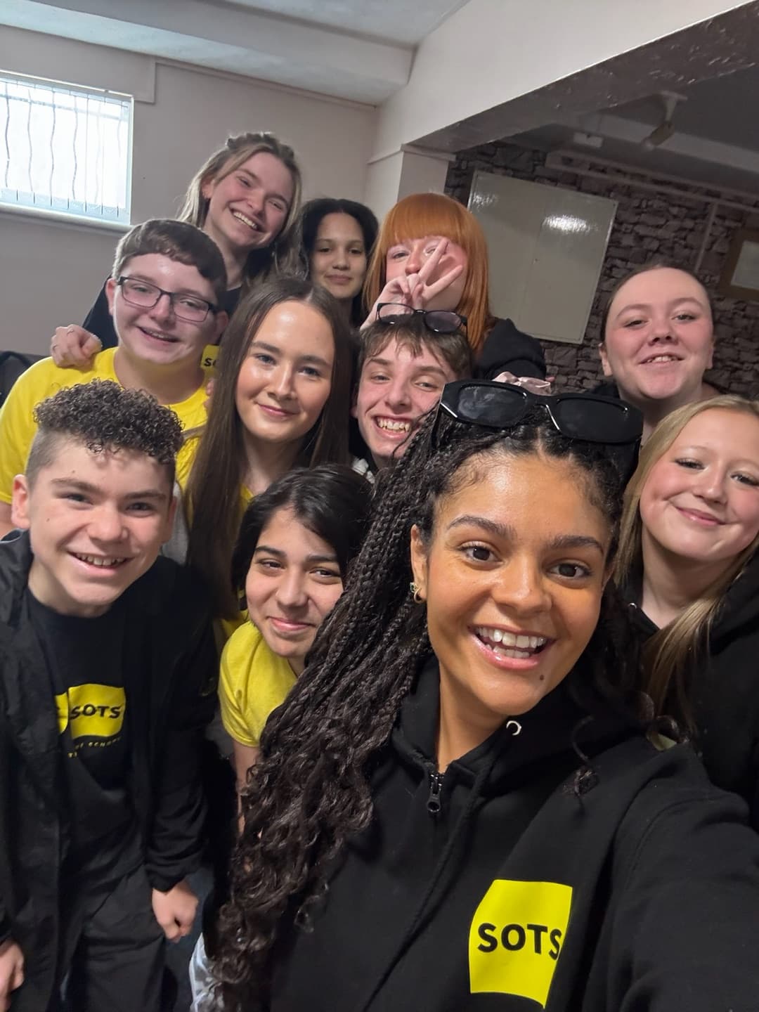 Senior Musical Theatre group selfie with the cast crowded into frame